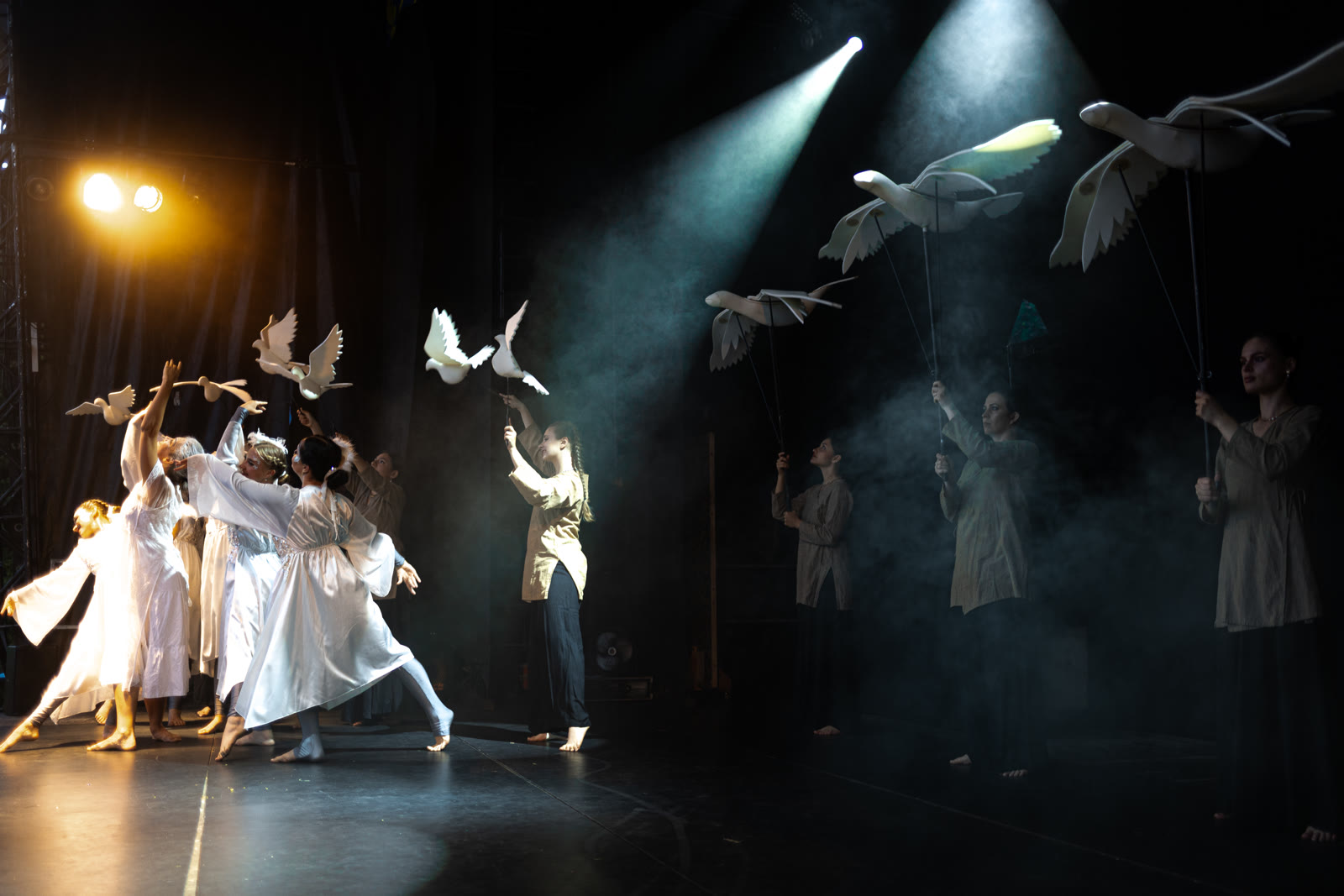 Dancers and doves under stage light