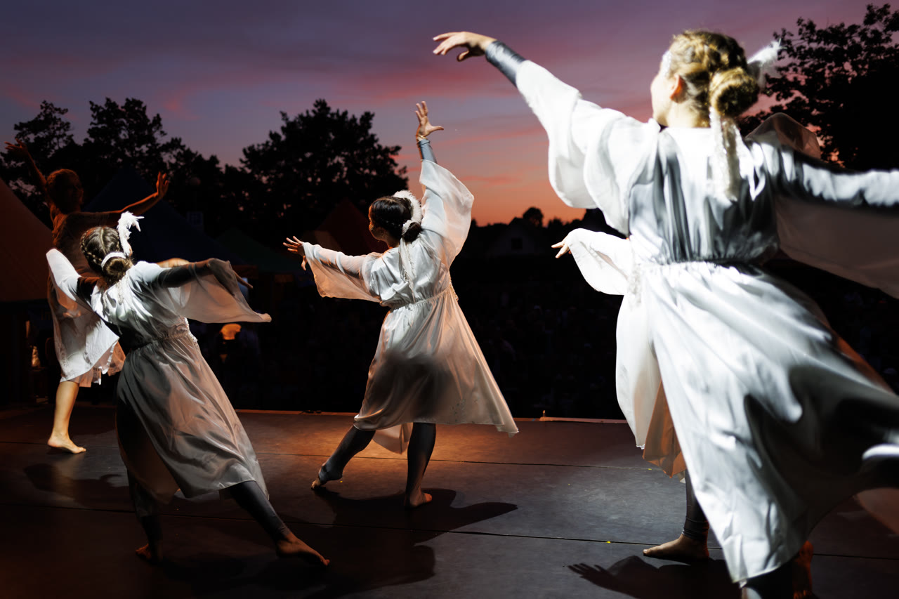 Dancers in white at sunset