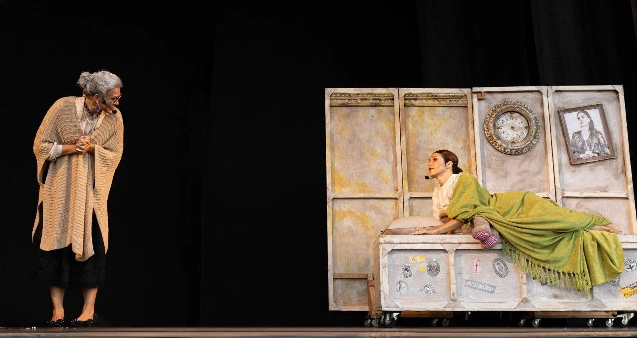 Grace and her granddaughter on a darkened stage