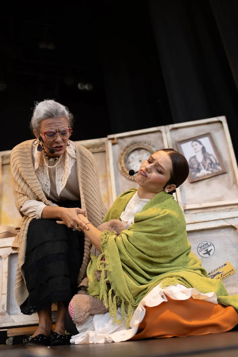 Grace holds her granddaughter's hand on stage